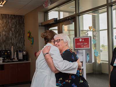 image of Laura Bond hugging Marilyn Lobsinger